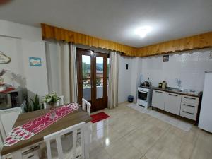 a kitchen with a table and a kitchen with a sink at loft harmonia in Blumenau