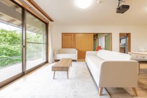 a living room with a white couch and a table at Hot spring inn Nonbiri -Ihatov Nakaizu- - Vacation STAY 51852v in Izu