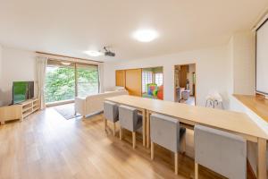 a dining room with a large wooden table and chairs at Hot spring inn Nonbiri -Ihatov Nakaizu- - Vacation STAY 51852v in Izu