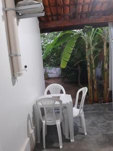 a white table and chairs on a patio at Suítes flor de Mandacaru in Piranhas