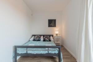 a small bedroom with a bed with blue sheets and pillows at Rybical 42 in Rybical +43 photos