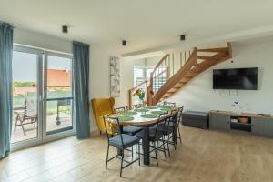 a kitchen and dining room with a table and chairs at Rybical 42 in Rybical