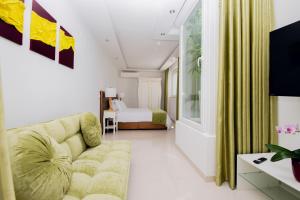 a living room with a couch and a bed at Giorgio Boutique Hotel in Sliema