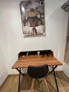 a wooden desk with a black cat sitting on top of it at La Parenthèse in Rouen