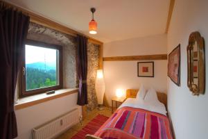a bedroom with a bed and a window at AlpenRetreat in Nassereith