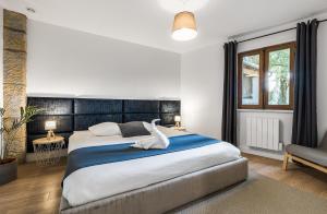 a bedroom with a large bed with a swan on it at L Écrin des Sieurs in Pougny