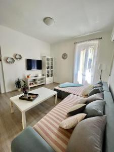 a living room with a couch and a table at Apartment JURIĆ in Lovran