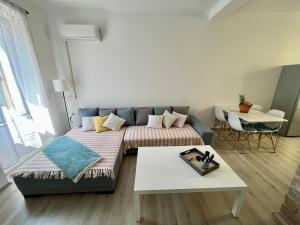 a living room with a couch and a table at Apartment JURIĆ in Lovran