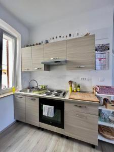 a kitchen with a stove and a counter top at Apartment JURIĆ in Lovran