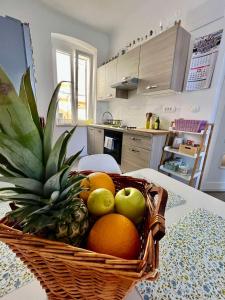 a basket of fruit on a table in a kitchen at Apartment JURIĆ in Lovran