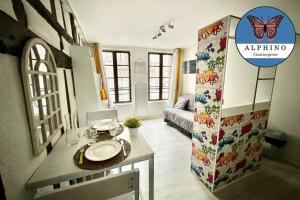 a bathroom with a sink and a refrigerator in a room at Le Petit Raspail, charme et authenticité in Limoges