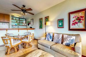 uma sala de estar com um sofá e uma mesa em Maunaloa Shores 403 em Hilo