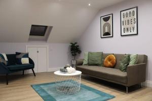 a living room with a couch and a chair at 5 star Apartment in London