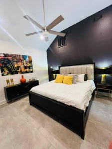 a bedroom with a large bed with a ceiling fan at Fab lil home Central to all NOLA / near City Park in New Orleans