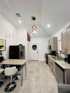 a large kitchen with a table and a counter top at Fab lil home Central to all NOLA / near City Park in New Orleans