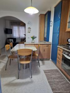 a kitchen with a table and chairs in a room at Apartamento Raxobrisamar in Raxo