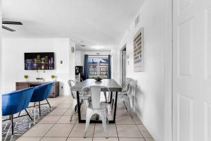a dining room with a table and blue chairs at Cheerful 4 Bedrooms house with Pool and Game Room in Hollywood