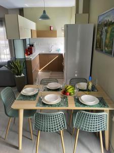 a kitchen with a table and chairs with plates and fruit on it at Chania Olive Home in Kato Daratso