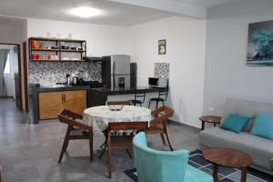a living room with a table and chairs and a kitchen at Centrico Departamento 401 in Cancún