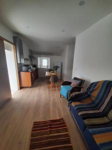 a living room with two couches and a table at Grandma villa in Pataias