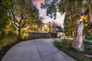 a driveway leading to a house with trees at Prestige Studio City Estate in Los Angeles