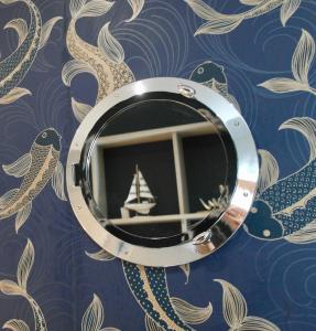 a mirror on a wall with a ship in it at York House Hotel in Whitley Bay