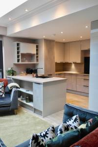 an open kitchen and living room with couches and a counter at York House Hotel in Whitley Bay