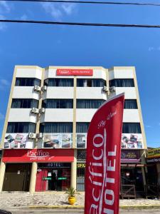 a building with a cocacola sign in front of it at Apart-Hotel Pacífico in Tramandaí