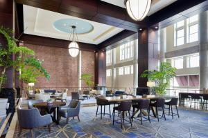 a restaurant with tables and chairs in a lobby at Lancaster Marriott at Penn Square in Lancaster