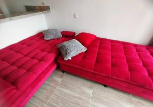 a large red couch sitting in a room at Espectacular Aparta Estudio Armenia Quindío in Armenia