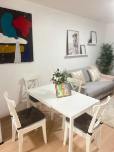 a white table and chairs in a living room at Very quiet apartment with balcony in Saint-Denis