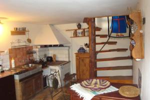 a kitchen with a stove and a sink and a ladder at Agroturystyka Kalina Wielka in Kalina Wielka