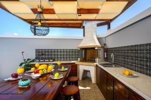 a kitchen with a wooden table with fruits on it at Pervolia House in Kremasti