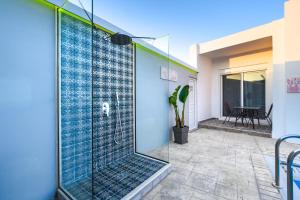 a glass shower in a house with a patio at Pervolia House Private Pool Near Airport in Kremasti