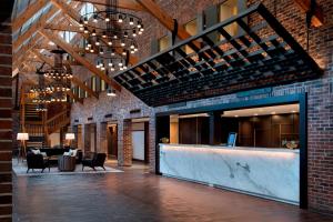 a lobby with a bar in a brick building at Princeton Marriott at Forrestal in Princeton