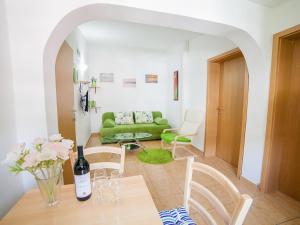 a living room with a green couch and a table at Apartments Viktorija in Petrovac na Moru