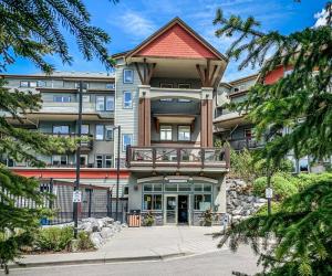 a large apartment building with a balcony at Beautiful Renovated Wolf 2Bed 2Bath in Canmore