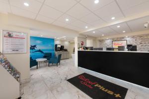 an office with a reception desk and a waiting area at Red Roof PLUS & Suites Virginia Beach - Seaside in Virginia Beach