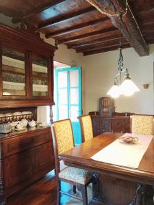 a dining room with a wooden table and chairs at Corredoira in Viveiro