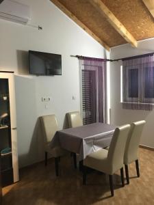 a dining room with a table and chairs at Apartments Sun & Sea in Vodice