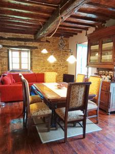 a dining room with a table and a couch at Corredoira in Viveiro +53 photos
