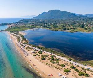 an aerial view of a beach and the ocean at Marina House next to Halikounas Beach in Halikounas