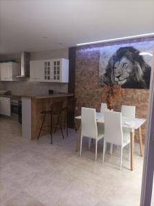 a kitchen and dining room with a table and chairs at CASA CONFORT in Grao de Castellón