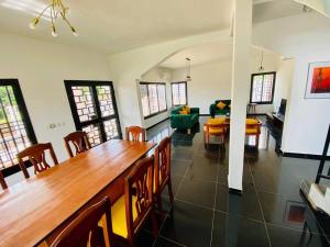 a dining room and living room with a table and chairs at Villa meublée au vert 