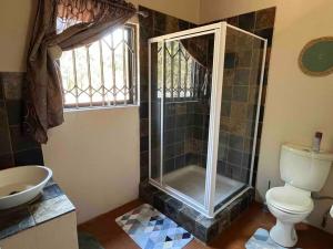a bathroom with a shower and a toilet and a sink at Hakuna Matata-Bela Bela in Moheme +21 photos