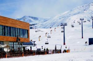 a ski slope with people on a ski lift at Zirve Hotel in Shahdag