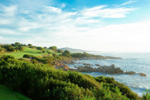 a view of a golf course overlooking the ocean at Due Lune Puntaldia Resort & Golf in San Teodoro