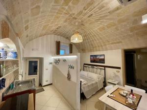 a bedroom with a bed and a sink in a room at Dimora Aversa in Monopoli