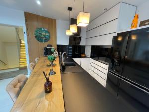 a kitchen with a long wooden counter in a room at Luxurious Panorama House with Pool and Sauna in Budaörs