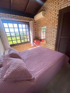 Giường trong phòng chung tại Casa de 3 Quartos em Garopaba - Bairro Ferraz